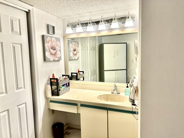 bathroom with a textured ceiling and vanity