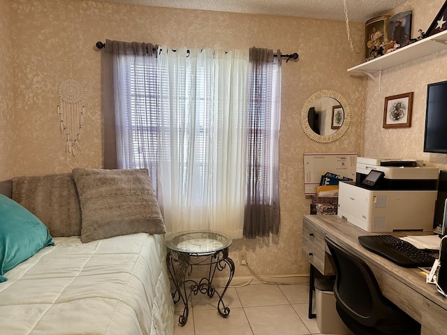 bedroom with a textured wall and tile patterned flooring
