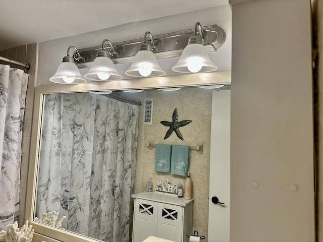 bathroom featuring visible vents and a shower with shower curtain