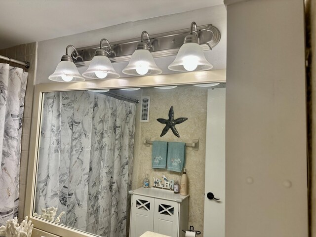bathroom with curtained shower and visible vents