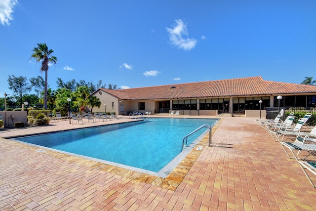 community pool featuring a patio and fence