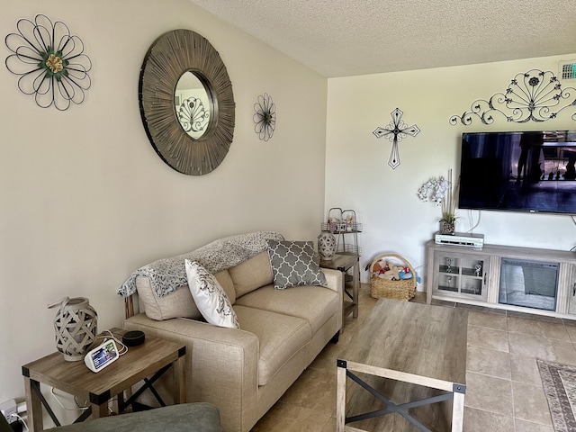 living room with tile patterned floors and a textured ceiling