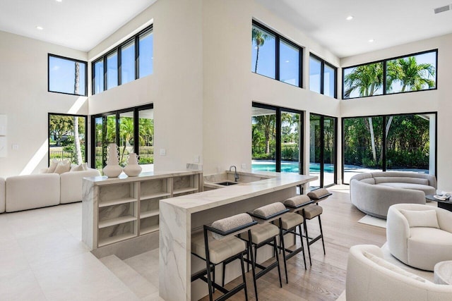 living area with plenty of natural light, recessed lighting, and visible vents