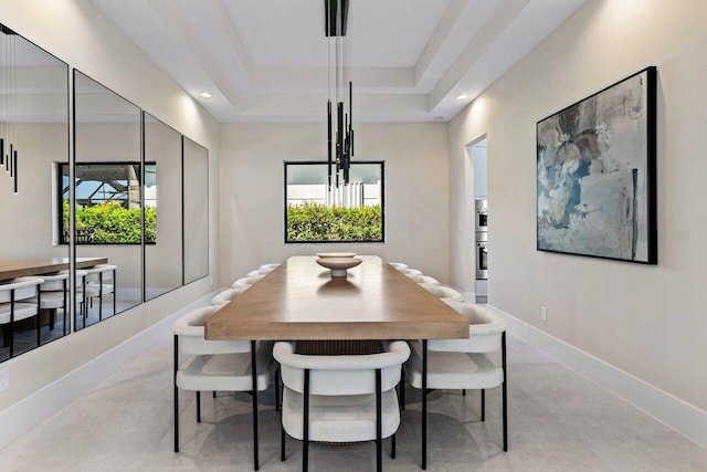 dining room with a raised ceiling, a notable chandelier, recessed lighting, and baseboards