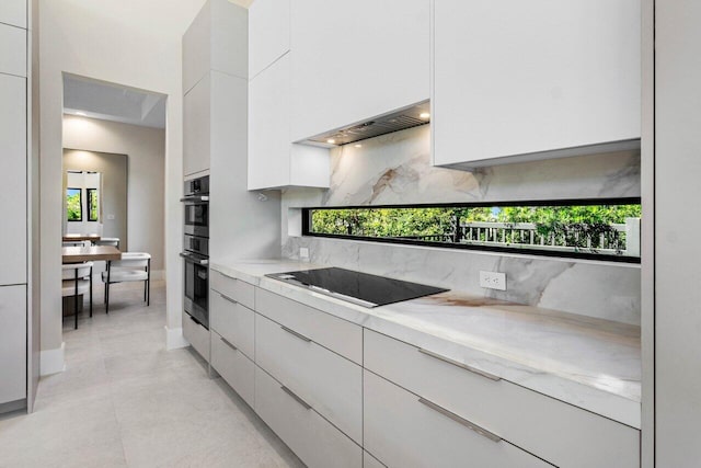 kitchen featuring black electric stovetop, decorative backsplash, stainless steel double oven, white cabinetry, and modern cabinets