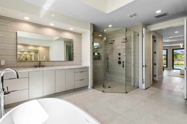 full bathroom with a soaking tub, visible vents, recessed lighting, and a stall shower