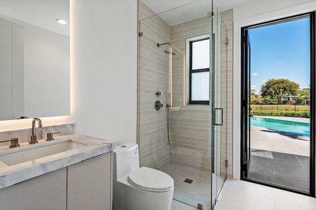 full bathroom with vanity, a shower stall, and toilet