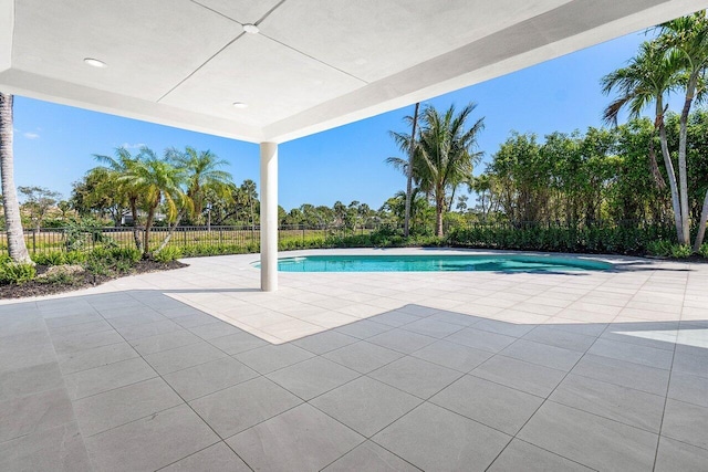 view of swimming pool featuring a fenced in pool, a patio area, and fence