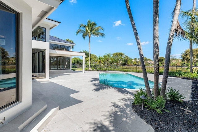 view of swimming pool with a patio area, a fenced in pool, and fence private yard