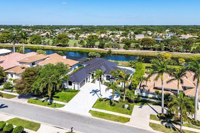 drone / aerial view with a residential view and a water view