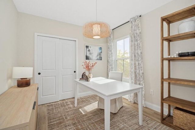 home office featuring baseboards and wood finished floors