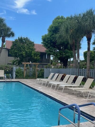 pool with a patio area and fence