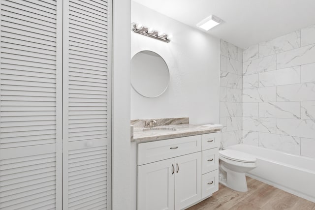 full bathroom featuring vanity, wood finished floors, a closet, shower / tub combination, and toilet