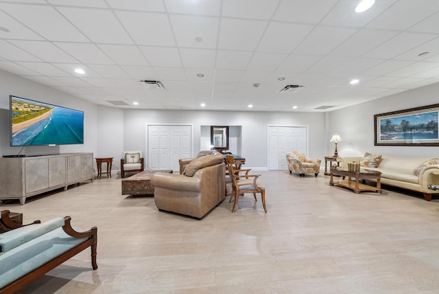 living area featuring recessed lighting, visible vents, and baseboards