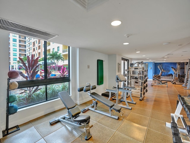 workout area featuring recessed lighting and baseboards