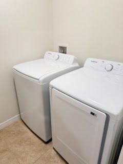 laundry area featuring laundry area, separate washer and dryer, and baseboards