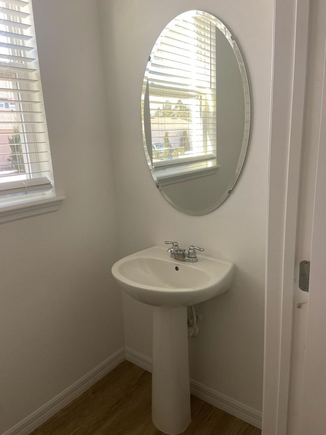 bathroom featuring baseboards and wood finished floors