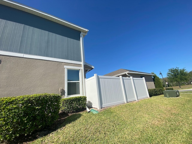 view of home's exterior with a yard and stucco siding