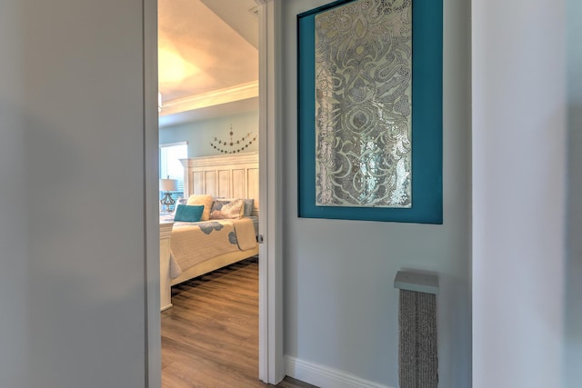 hallway with baseboards and wood finished floors