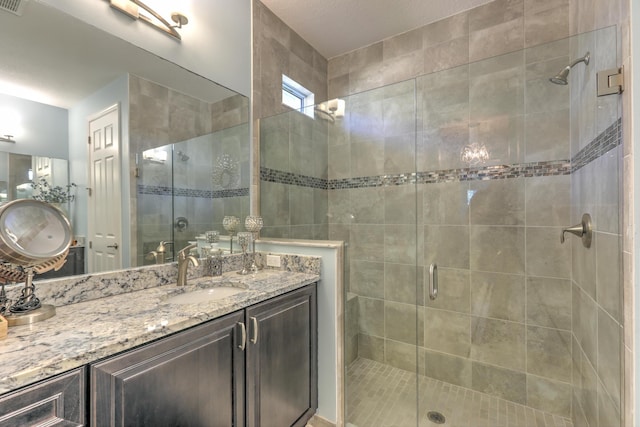 bathroom featuring vanity and a stall shower