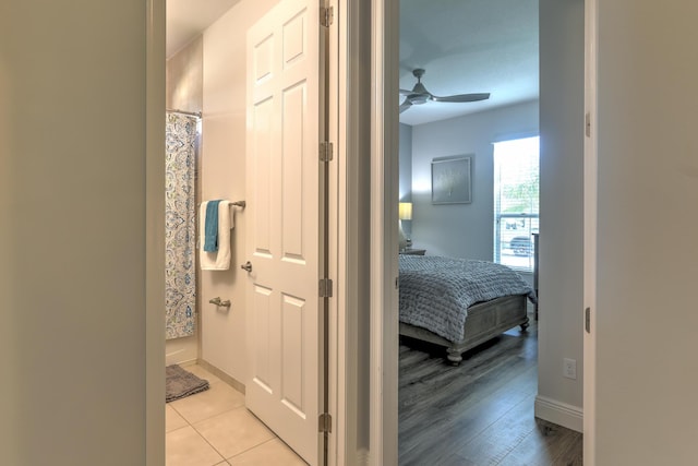 hallway with baseboards and light wood finished floors