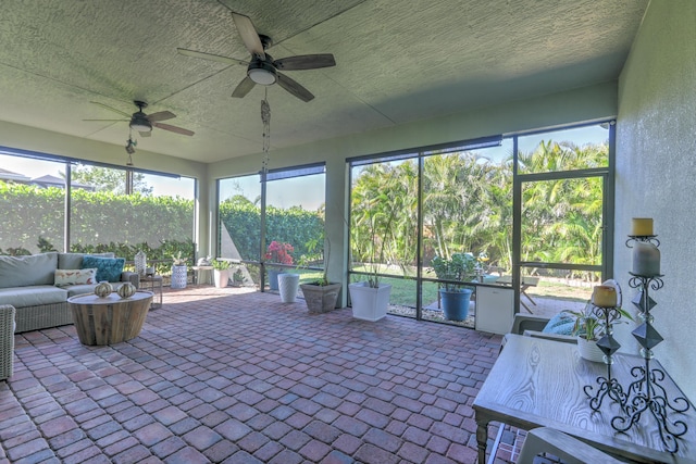 unfurnished sunroom featuring ceiling fan