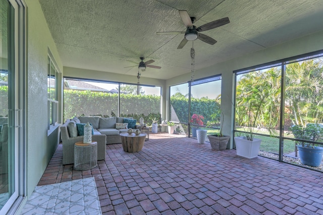 unfurnished sunroom with a ceiling fan