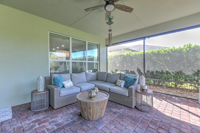 sunroom / solarium with a healthy amount of sunlight and a ceiling fan