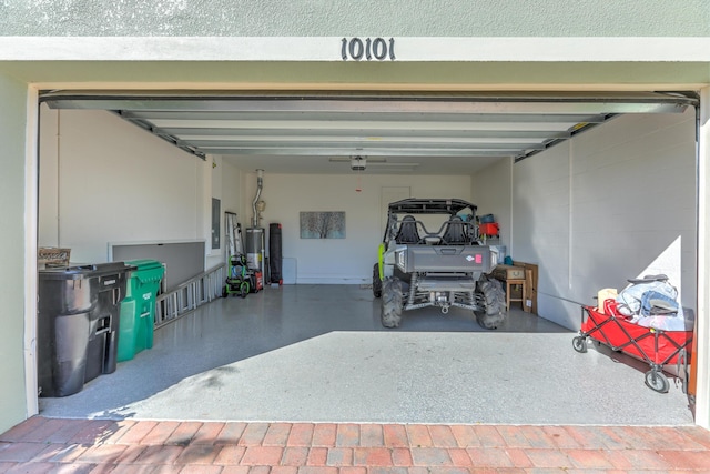 garage featuring electric panel and gas water heater