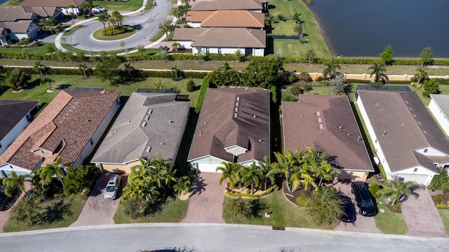 drone / aerial view with a residential view and a water view