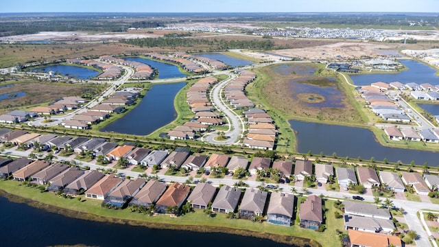 birds eye view of property featuring a residential view and a water view