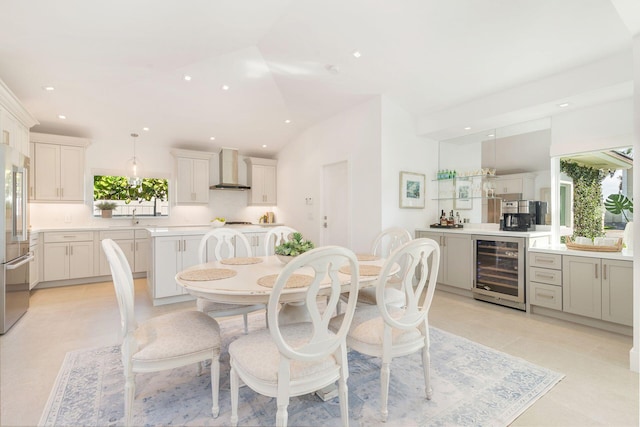 dining room featuring wine cooler, recessed lighting, lofted ceiling, and light tile patterned flooring