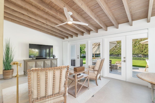 sunroom / solarium featuring french doors, beam ceiling, wooden ceiling, and a ceiling fan