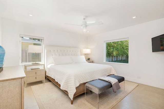 bedroom with multiple windows, a ceiling fan, and baseboards