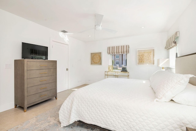 bedroom with light tile patterned floors, visible vents, baseboards, and a ceiling fan