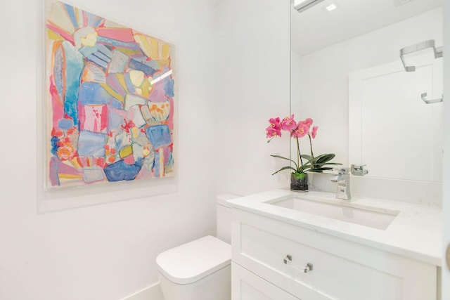 bathroom with toilet and vanity