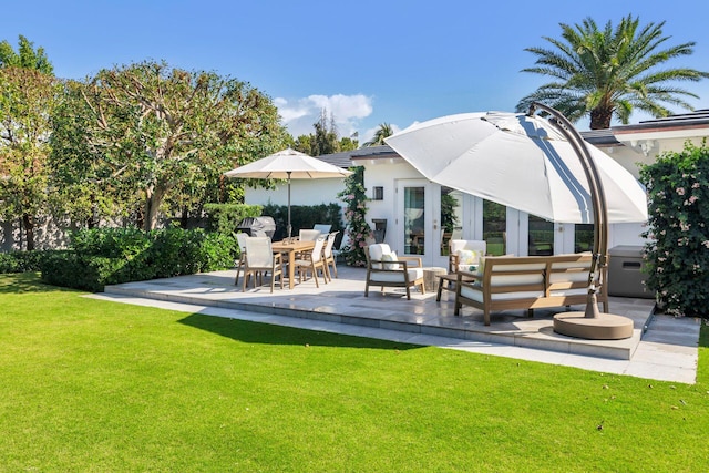 rear view of house featuring a patio, a yard, an outdoor living space, and stucco siding