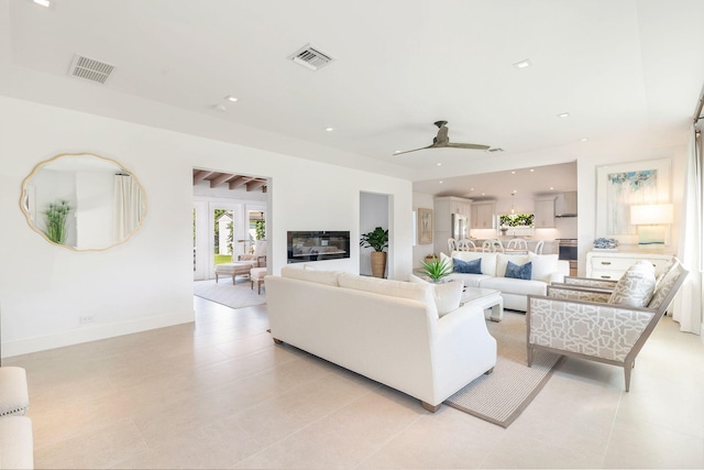 living room featuring visible vents, recessed lighting, baseboards, and a glass covered fireplace