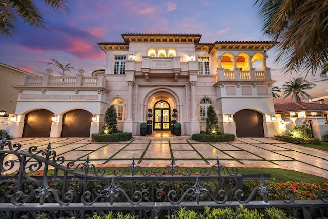 4216 Intracoastal Dr, Highland Beach, FL 33487 - mediterranean / spanish-style house featuring a balcony, french doors, driveway, and a fenced front yard