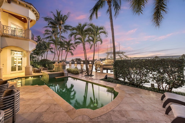 4216 Intracoastal Dr, Highland Beach, FL 33487 - pool at dusk featuring a patio and an outdoor pool
