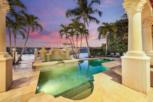 4216 Intracoastal Dr, Highland Beach, FL 33487 - pool at dusk with an outdoor pool, a patio area, and a water view