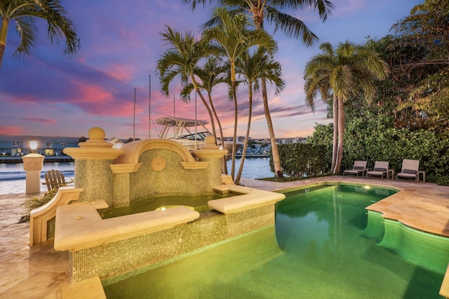 4216 Intracoastal Dr, Highland Beach, FL 33487 - pool at dusk featuring a water view and an outdoor pool