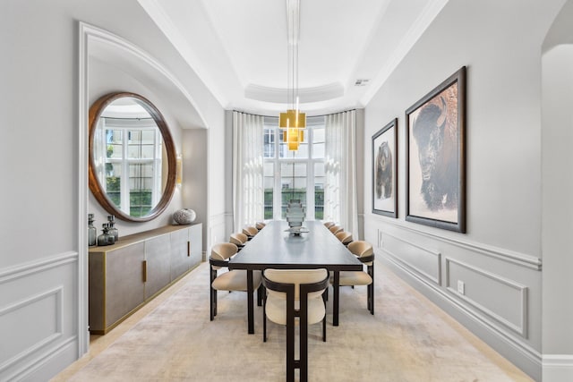 4216 Intracoastal Dr, Highland Beach, FL 33487 - dining area featuring ornamental molding, a decorative wall, a raised ceiling, healthy amount of natural light, and a wainscoted wall