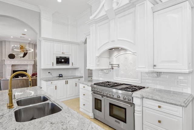 4216 Intracoastal Dr, Highland Beach, FL 33487 - kitchen featuring double oven range, a sink, white cabinets, ornamental molding, and recessed lighting