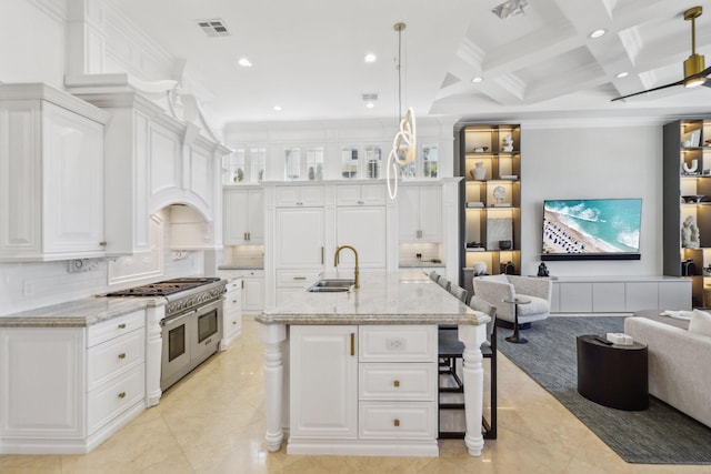 4216 Intracoastal Dr, Highland Beach, FL 33487 - kitchen with double oven range, open floor plan, a sink, beamed ceiling, and white cabinetry
