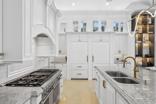 4216 Intracoastal Dr, Highland Beach, FL 33487 - kitchen featuring a sink, high end range, white cabinets, and recessed lighting