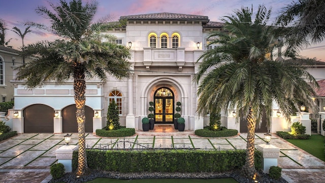 4216 Intracoastal Dr, Highland Beach, FL 33487 - mediterranean / spanish-style home with french doors, concrete driveway, an attached garage, and stucco siding