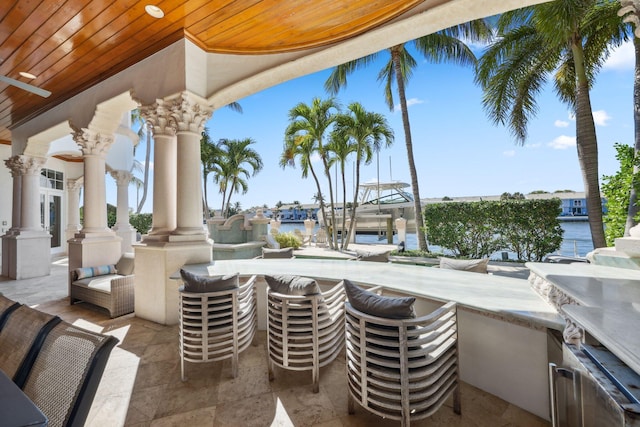 4216 Intracoastal Dr, Highland Beach, FL 33487 - view of patio / terrace with a water view, boat lift, and a boat dock