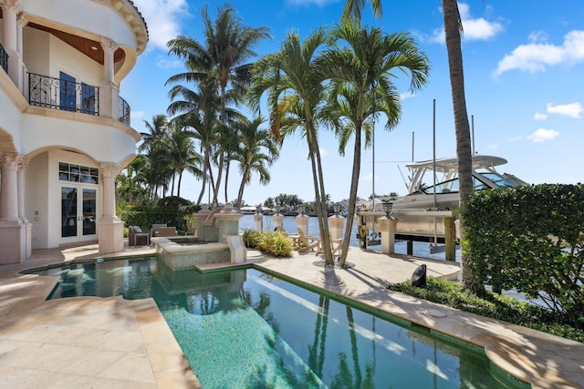 4216 Intracoastal Dr, Highland Beach, FL 33487 - view of swimming pool with french doors, a patio area, boat lift, a pool with connected hot tub, and a boat dock