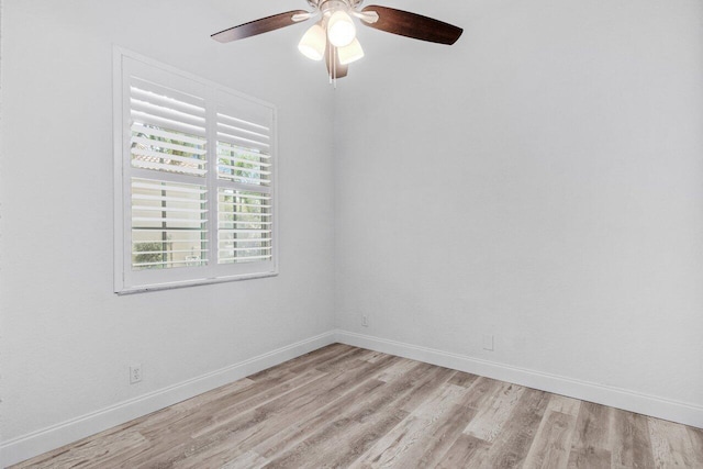 unfurnished room with a ceiling fan, baseboards, and light wood-type flooring